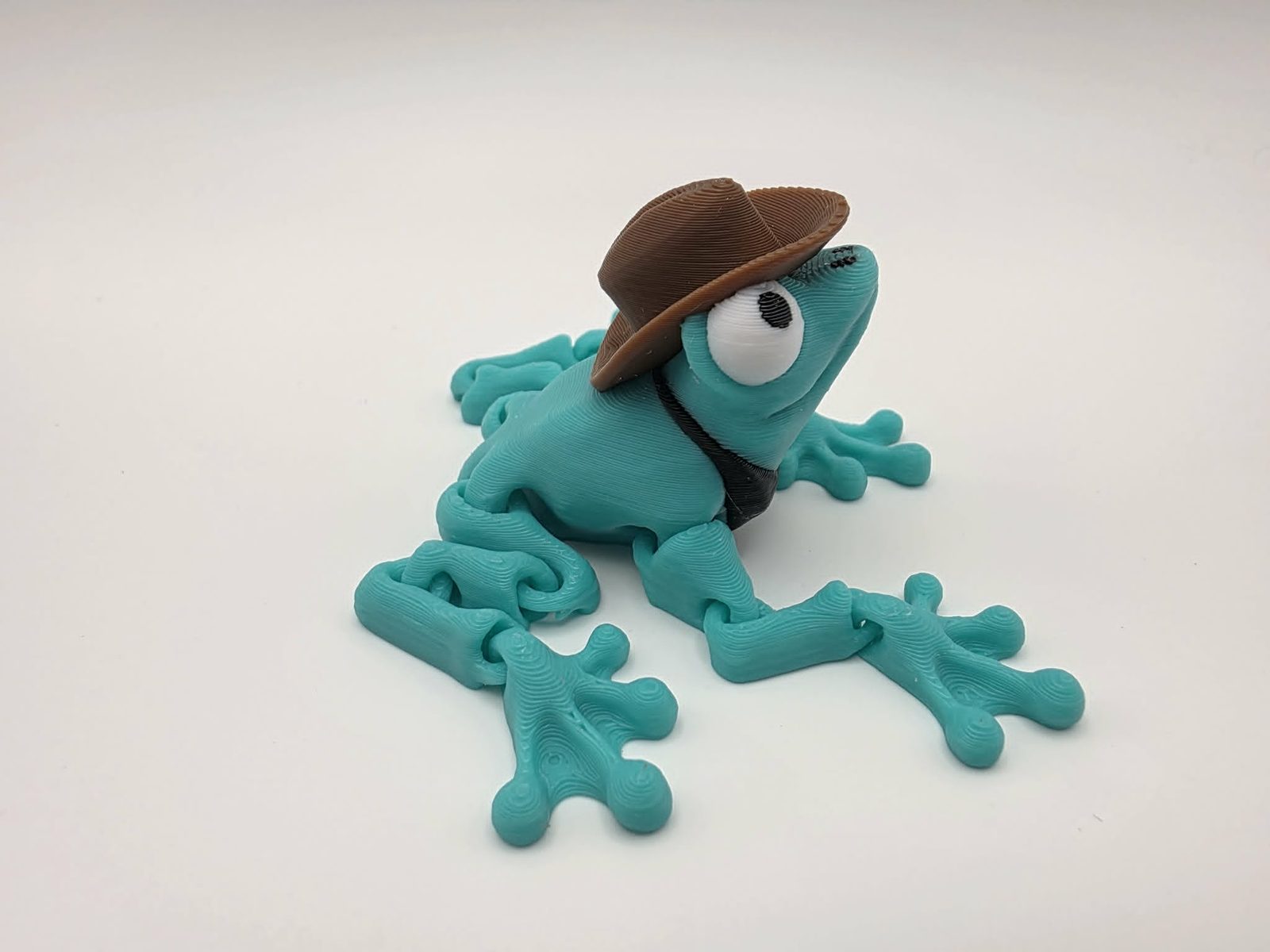 Cowboy Frog - Cowboy Croaker - 2.5" Long x 3.5" Wide from Tip of Toe to Tip of Toe x 1.5" Tall - Mint Green, Chocolate, Black, White 3D printed item image