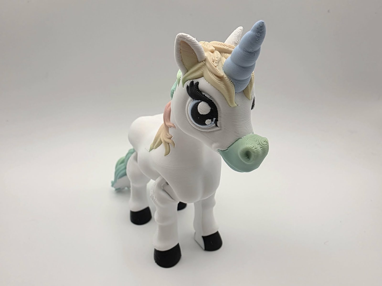 Unicorn - Pastel Dream - 5" Long x 1.5" Wide x 4.25" Tall - White, Matte Rainbow, Black, Blue and White 3D printed item image