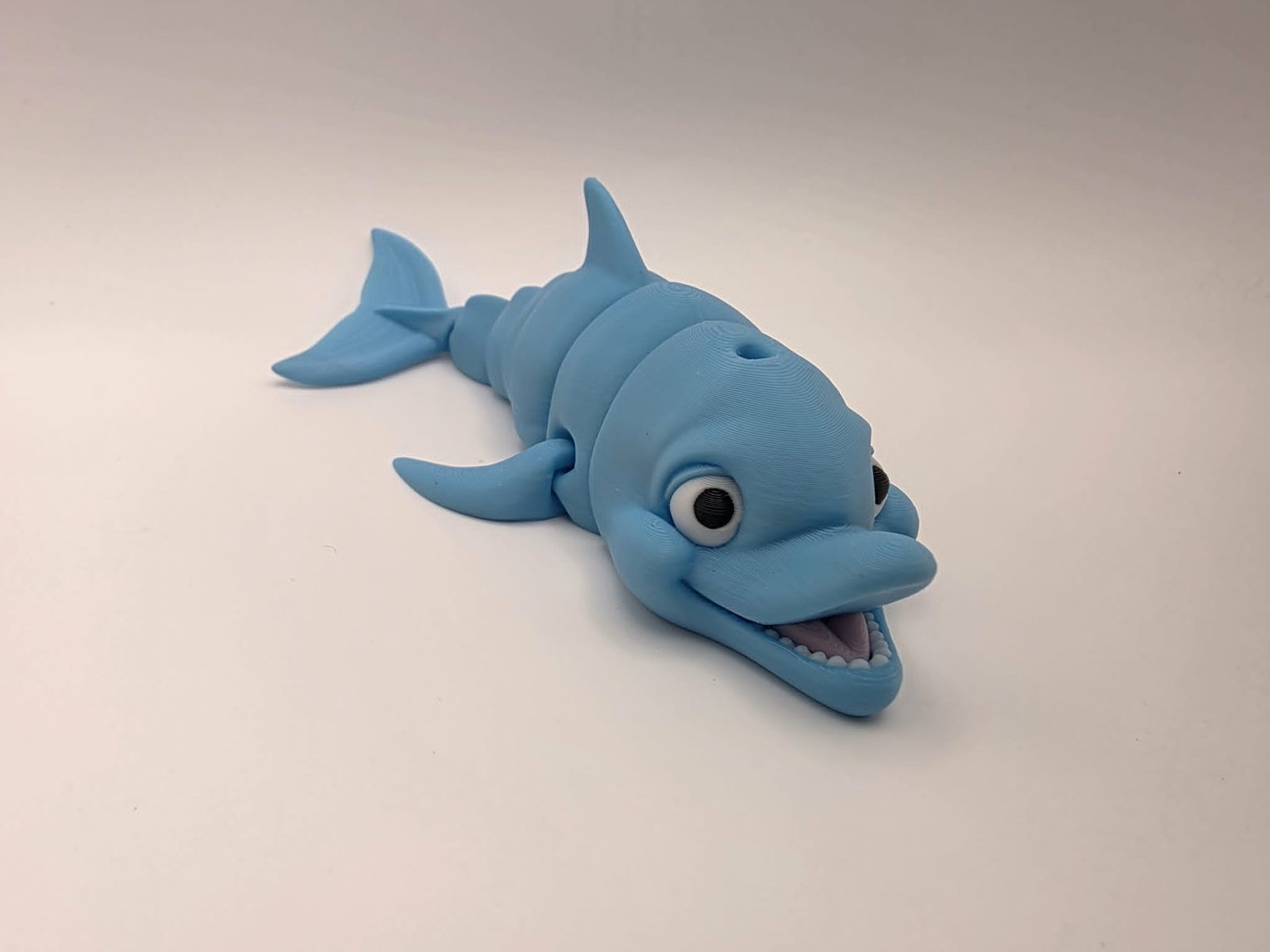 Dolphins - Ocean Giggles - 6" Long x 3.5" Wide Tip of Fin to Tip of Fin x 1.5" Tall - Sky Blue, White, Black, Sakura Pink 3D printed item image