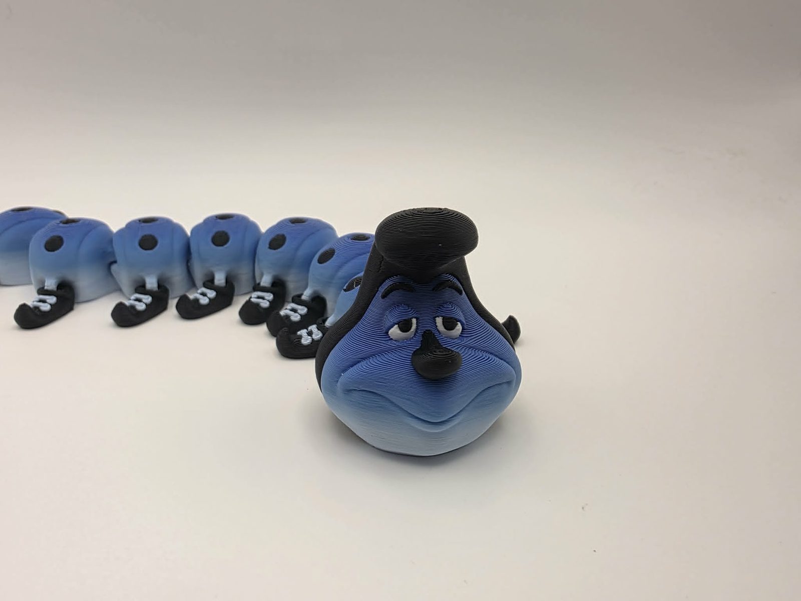 Caterpillar - Blueberry Scoot - 8" Long x 2.25 Tip of Shoe to Tip of Shoe x 1.75" Tall - Blue and White, Black, White 3D printed item image