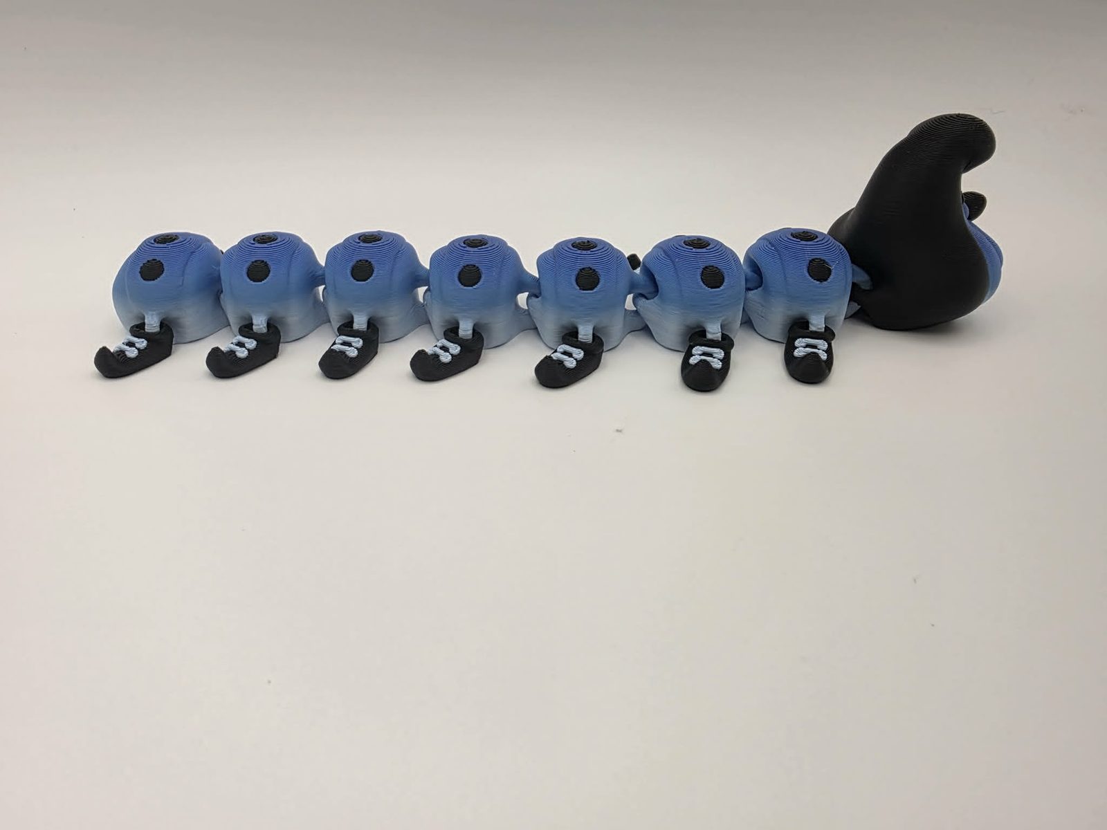 Caterpillar - Blueberry Scoot - 8" Long x 2.25 Tip of Shoe to Tip of Shoe x 1.75" Tall - Blue and White, Black, White 3D printed item image