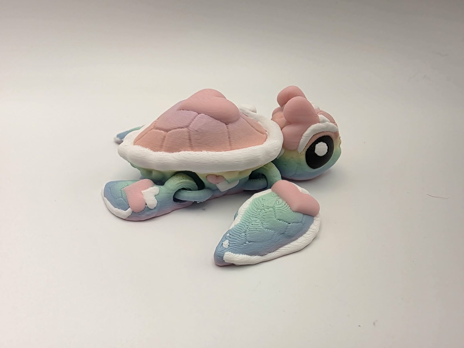 Heart Turtle - Rainbow Heart Splash - 3.5" Long x 3.5" Wide Tip of Fin to Tip of Fin x 1.25" Tall - Matte Rainbow, Sakura Pink, White, Black 3D printed item image