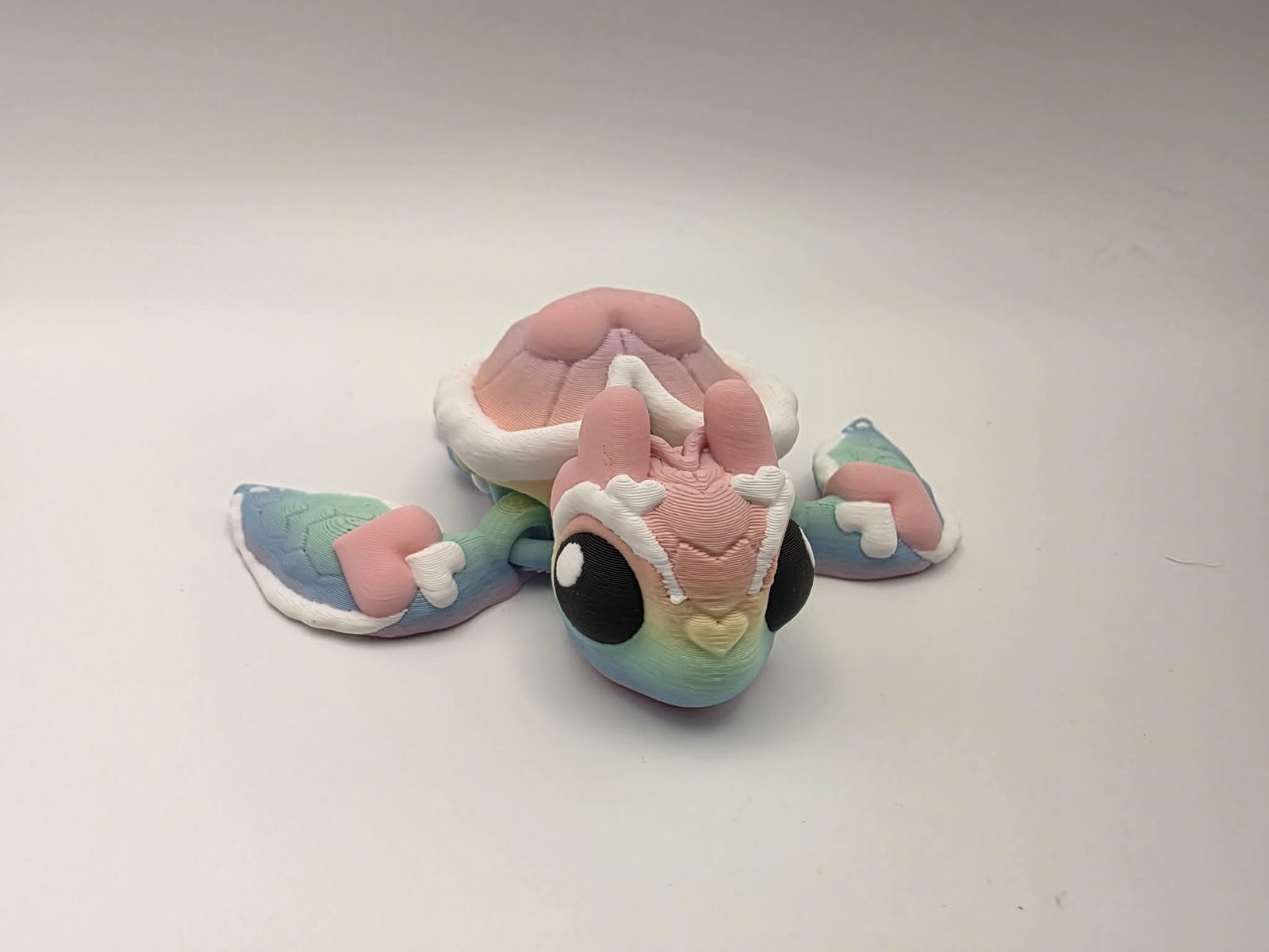 Heart Turtle - Rainbow Heart Splash - 3.5" Long x 3.5" Wide Tip of Fin to Tip of Fin x 1.25" Tall - Matte Rainbow, Sakura Pink, White, Black 3D printed item image