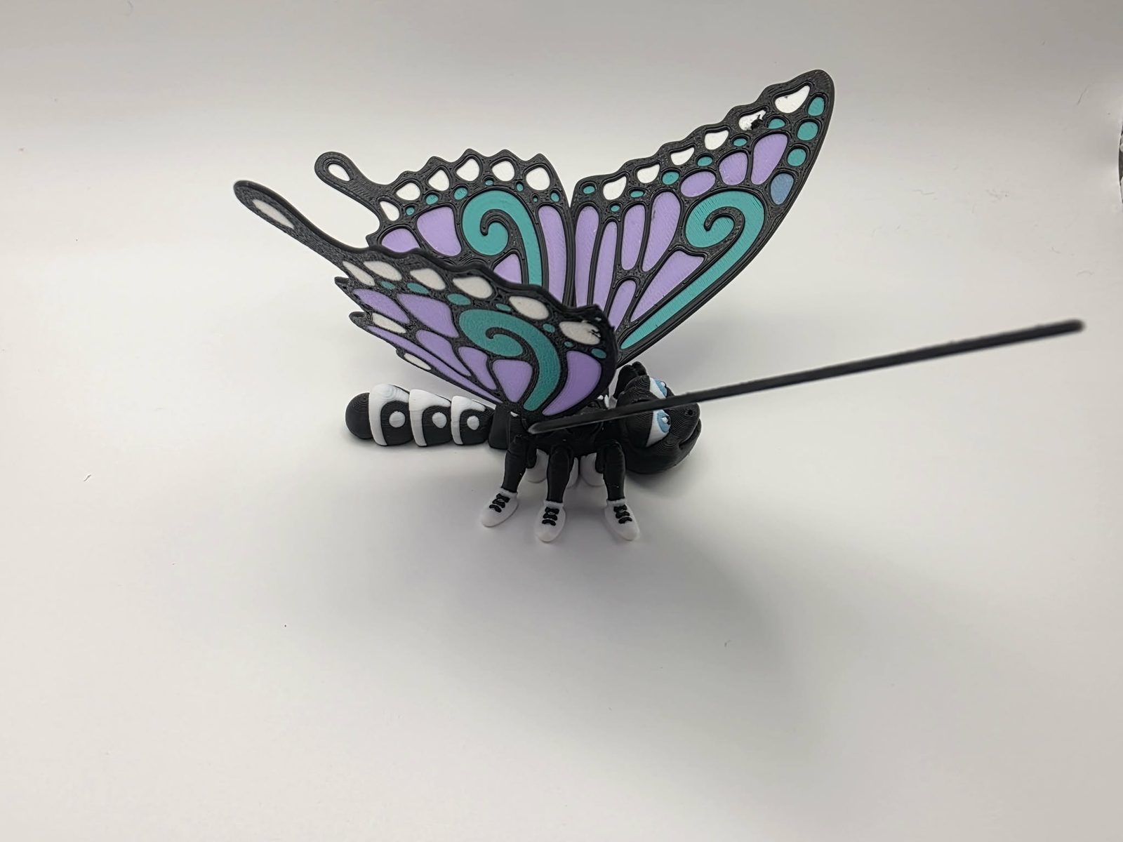 Butterfly - Mint Meadow Butterfly - 5" Long Tip of Wing to Tip of Wing x 5" Wide Tip of Wing to Tip of Wing x 2.25" Tall - Black, White, Sky Blue, Mint Green 3D printed item image