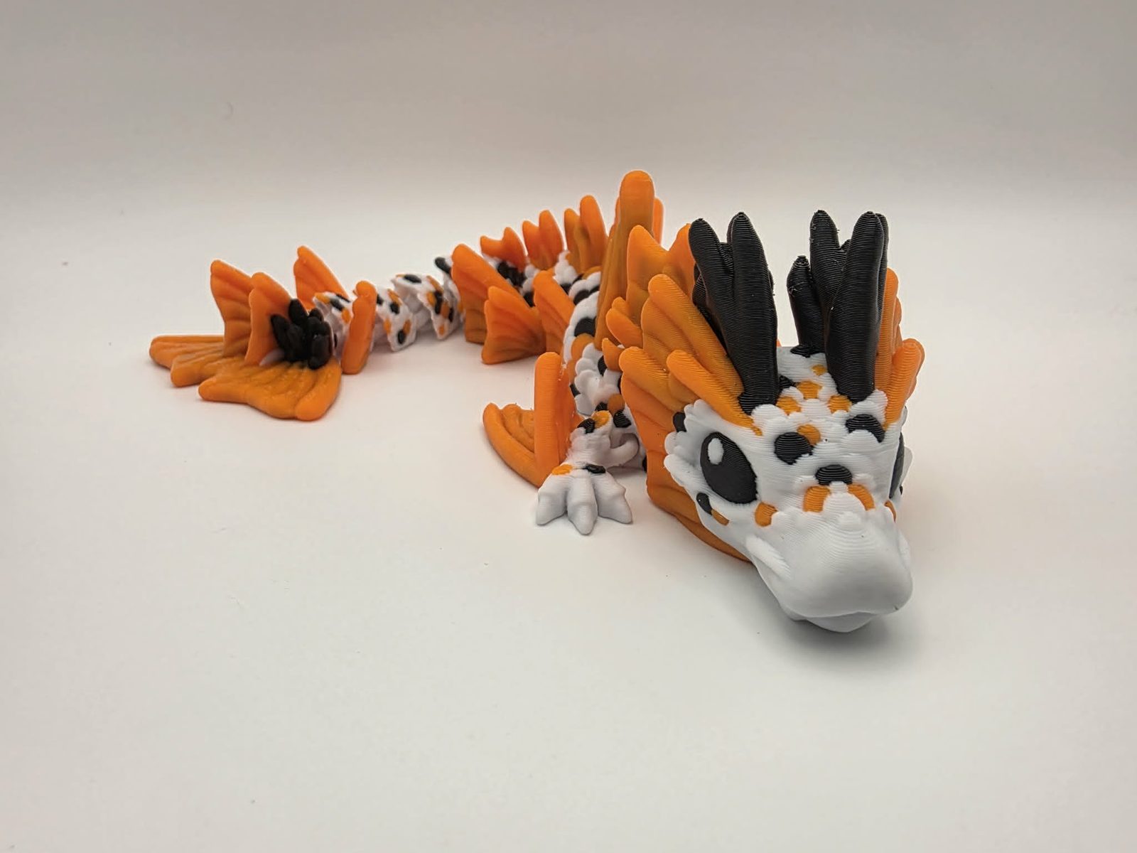 Koi Dragon - Pond Spirit Dragon - 9" Long x 2.75" Wide x 1.75" Tall - White, Sunny Orange, Black 3D printed item image