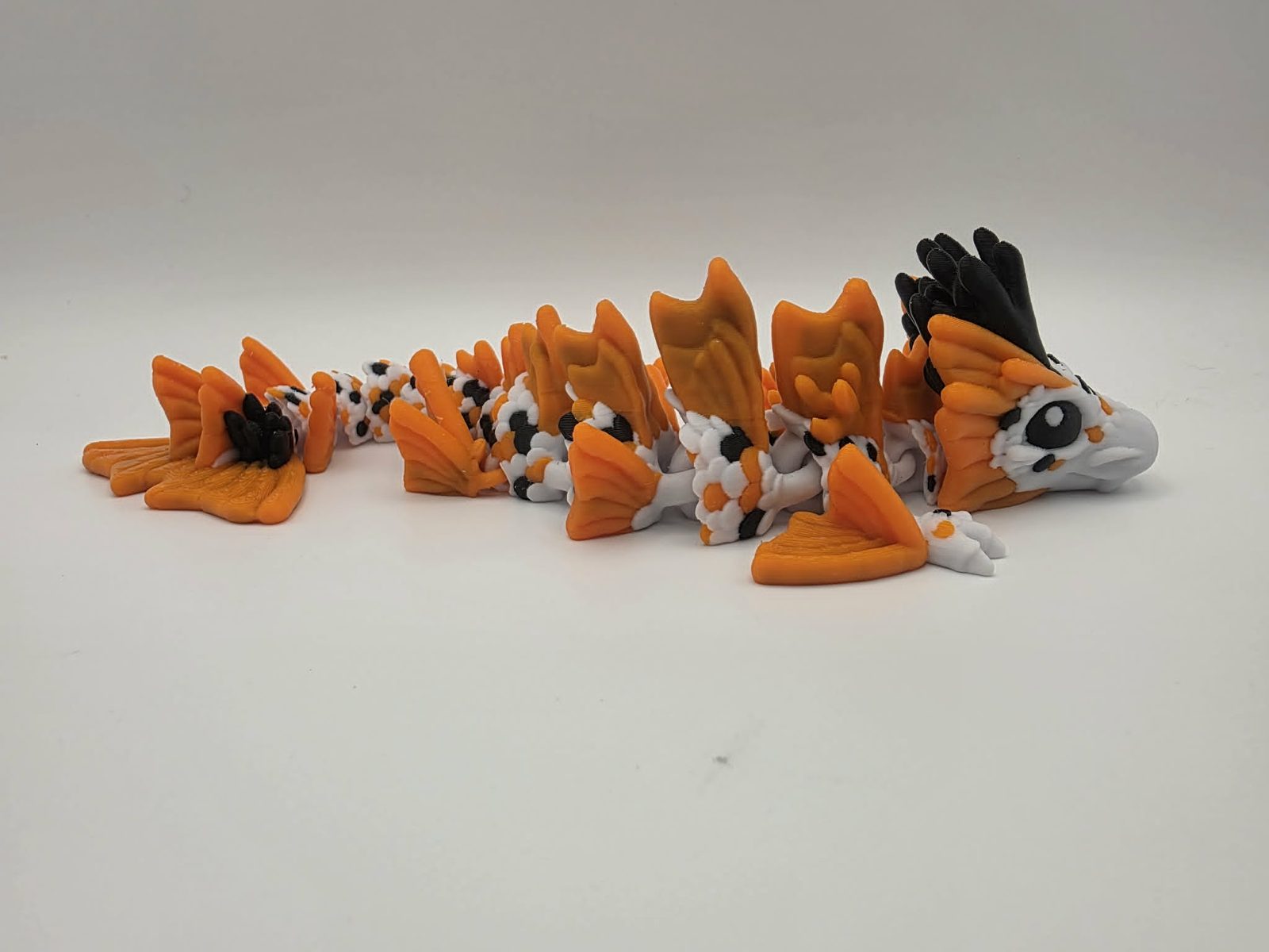 Koi Dragon - Pond Spirit Dragon - 9" Long x 2.75" Wide x 1.75" Tall - White, Sunny Orange, Black 3D printed item image