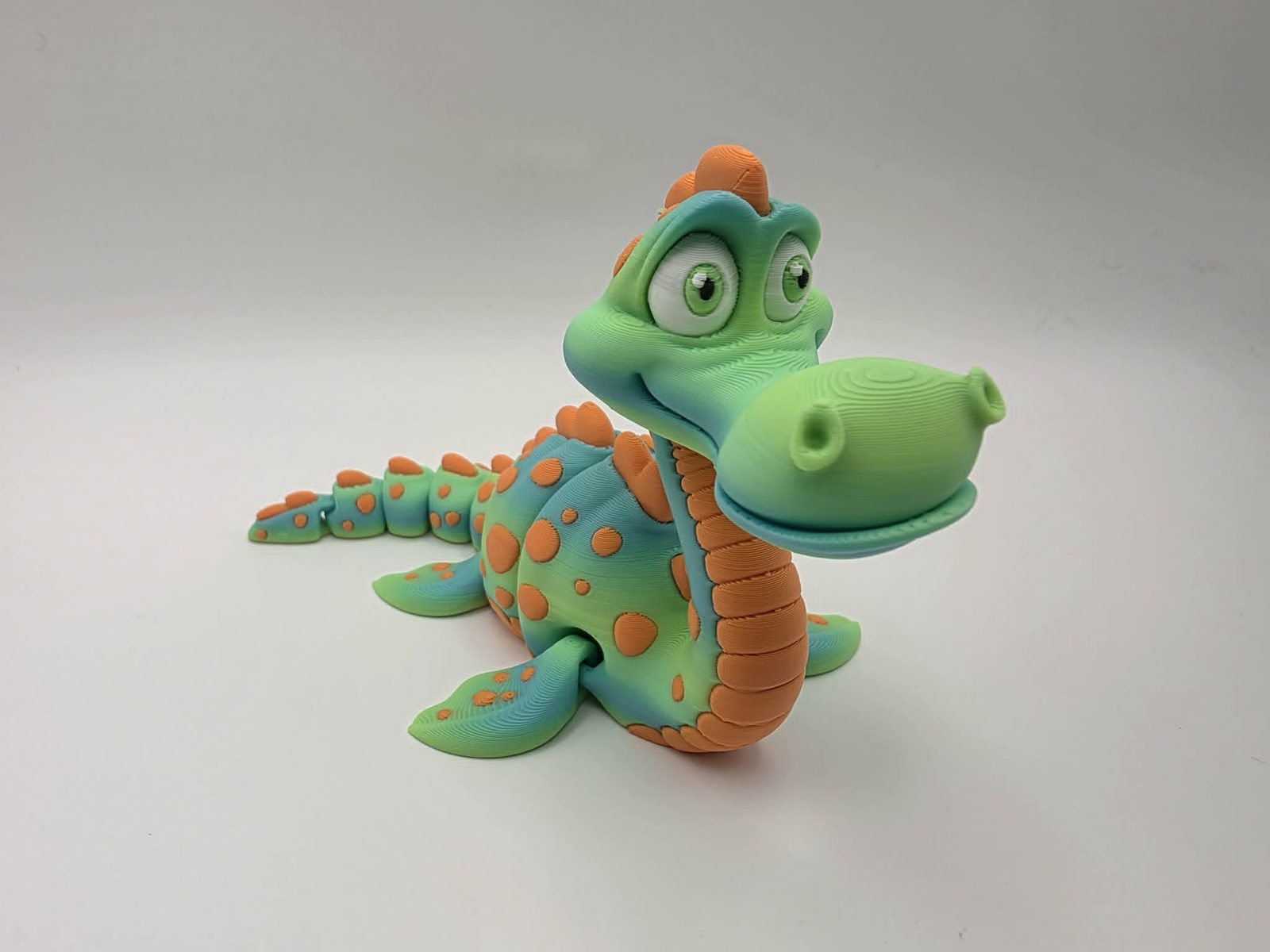 Loch Ness Monster - Nessy - 6" Long x 3" Wide Fin to Fin x 3" Tall - Matte Yellow Green Rainbow, Sunny Orange, White, Black 3D printed item image